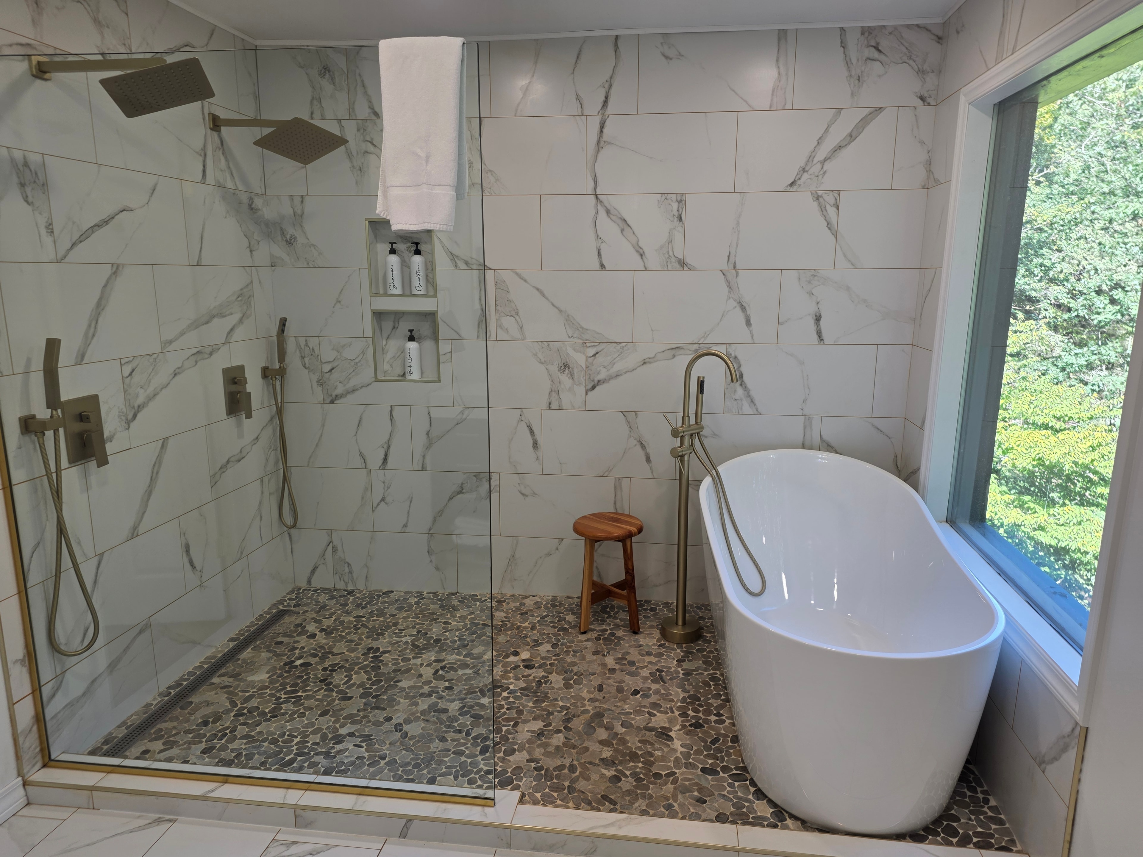 Marble spa bathroom with freestanding tub and walk-in shower