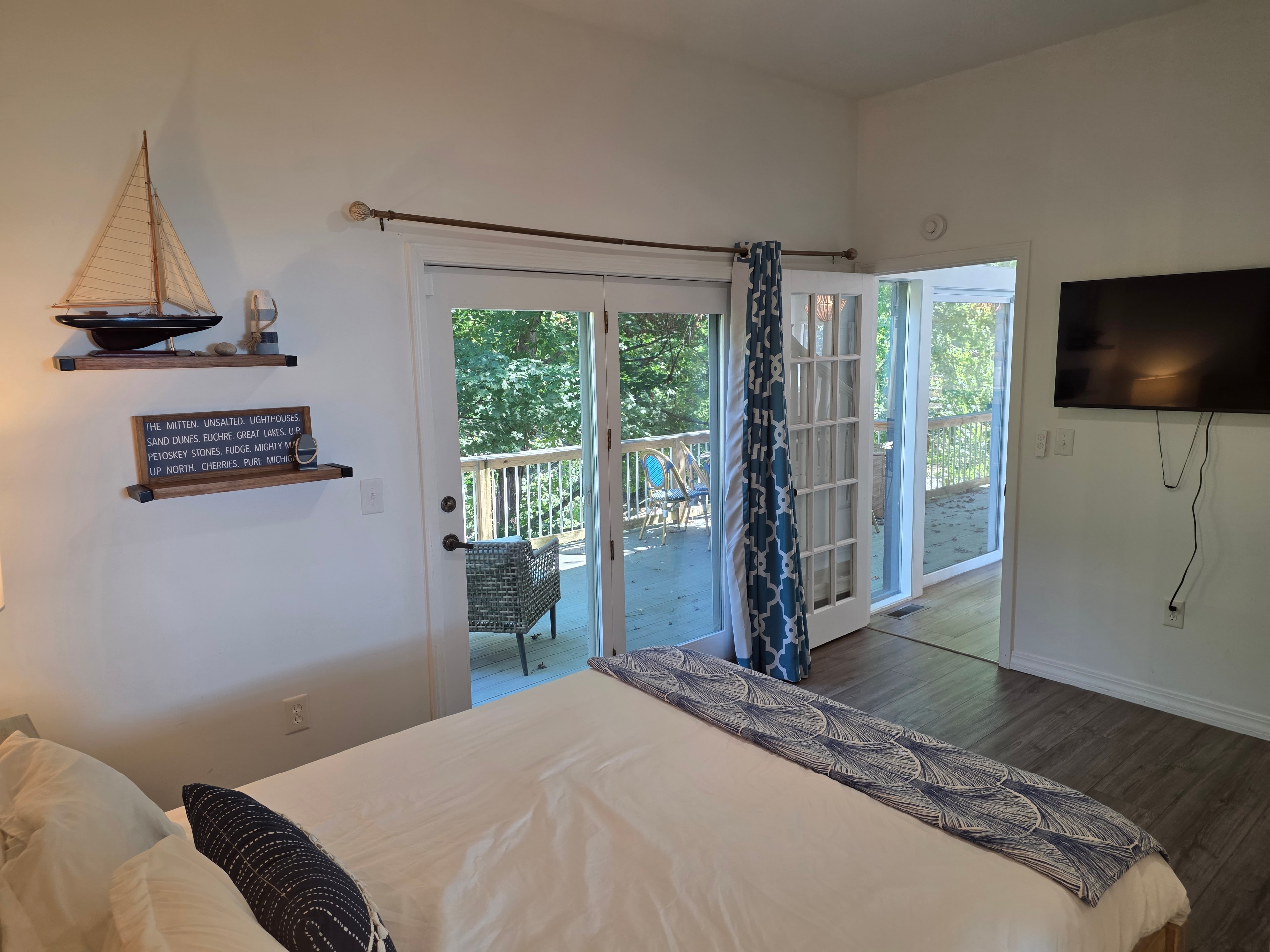 Coastal bedroom with lake view doors
