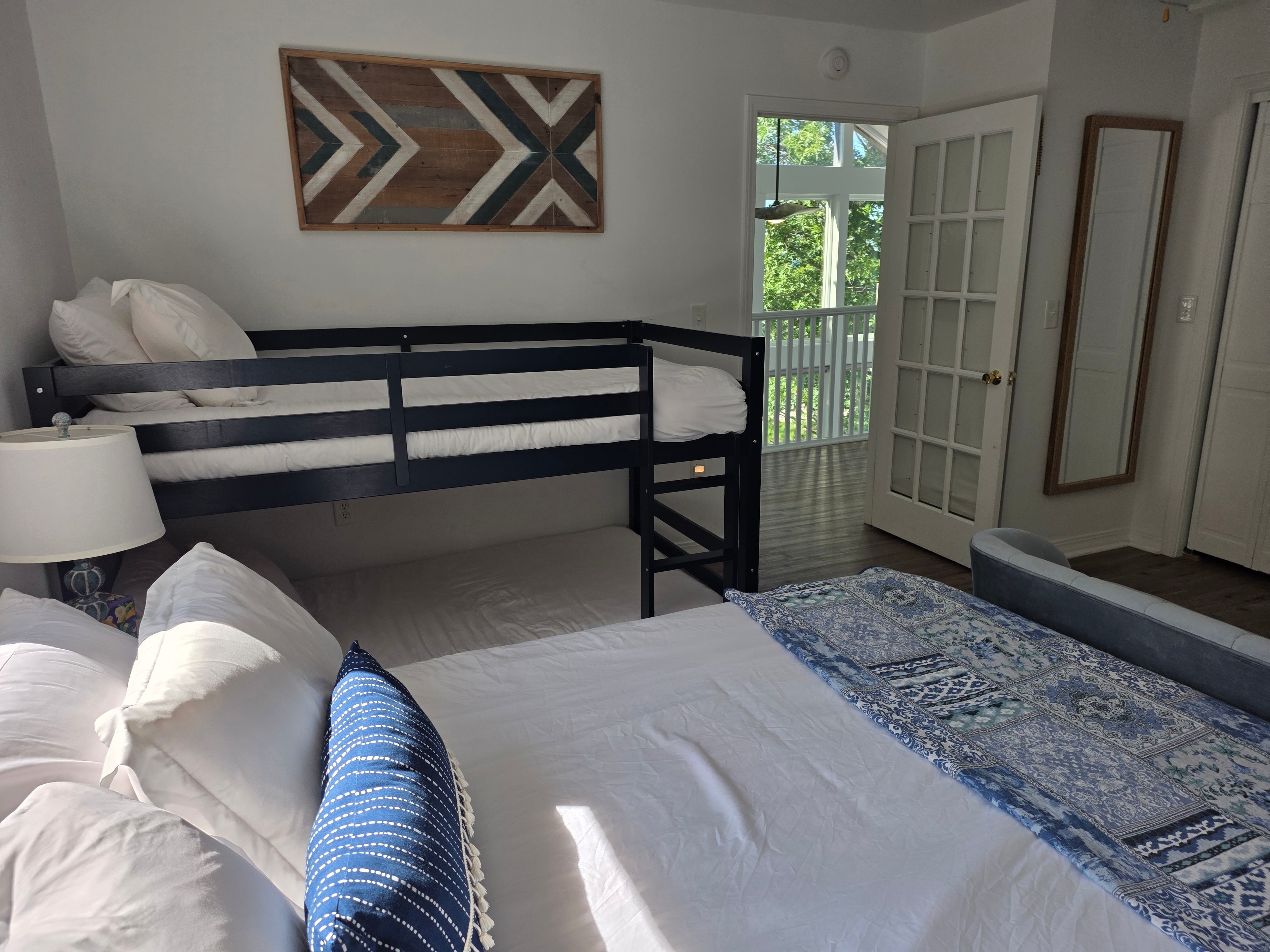 Bedroom with bunk bed and French doors to deck