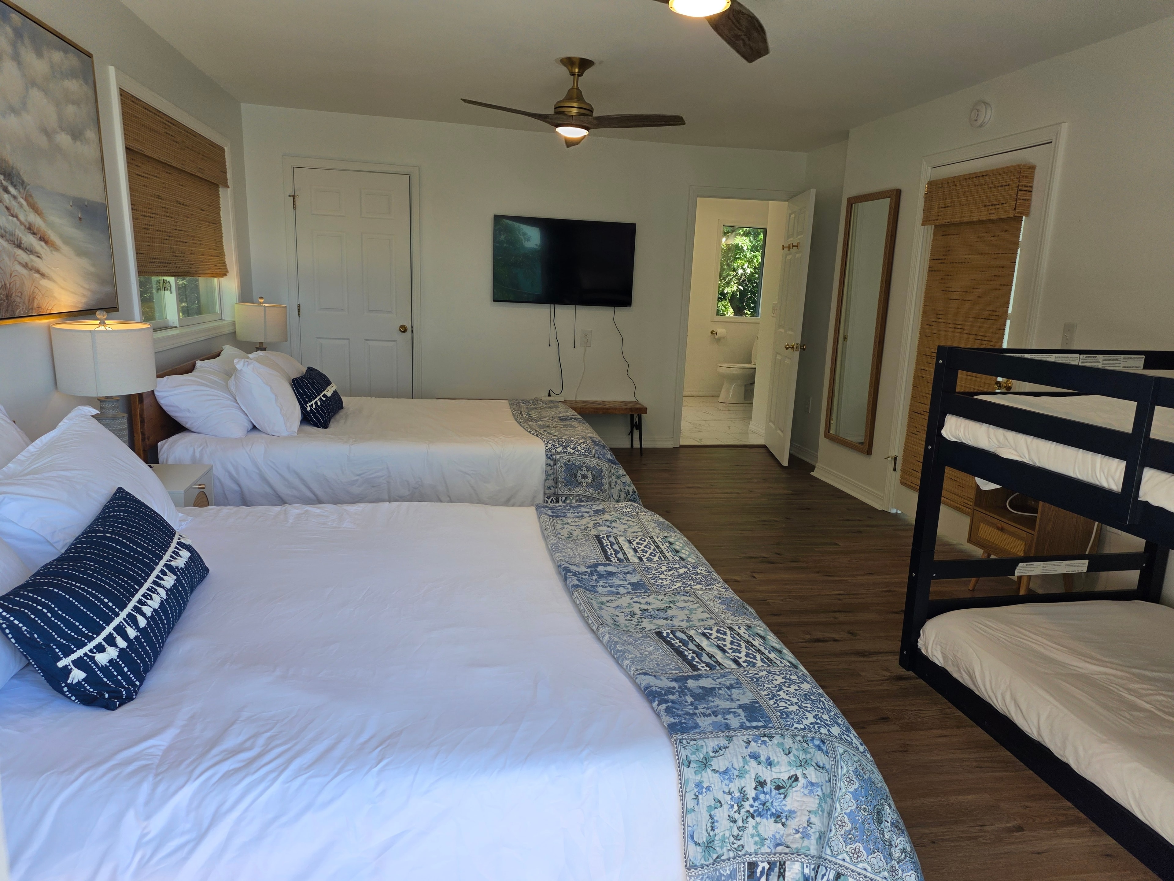 Spacious bedroom with two queens, bunk bed, and en suite