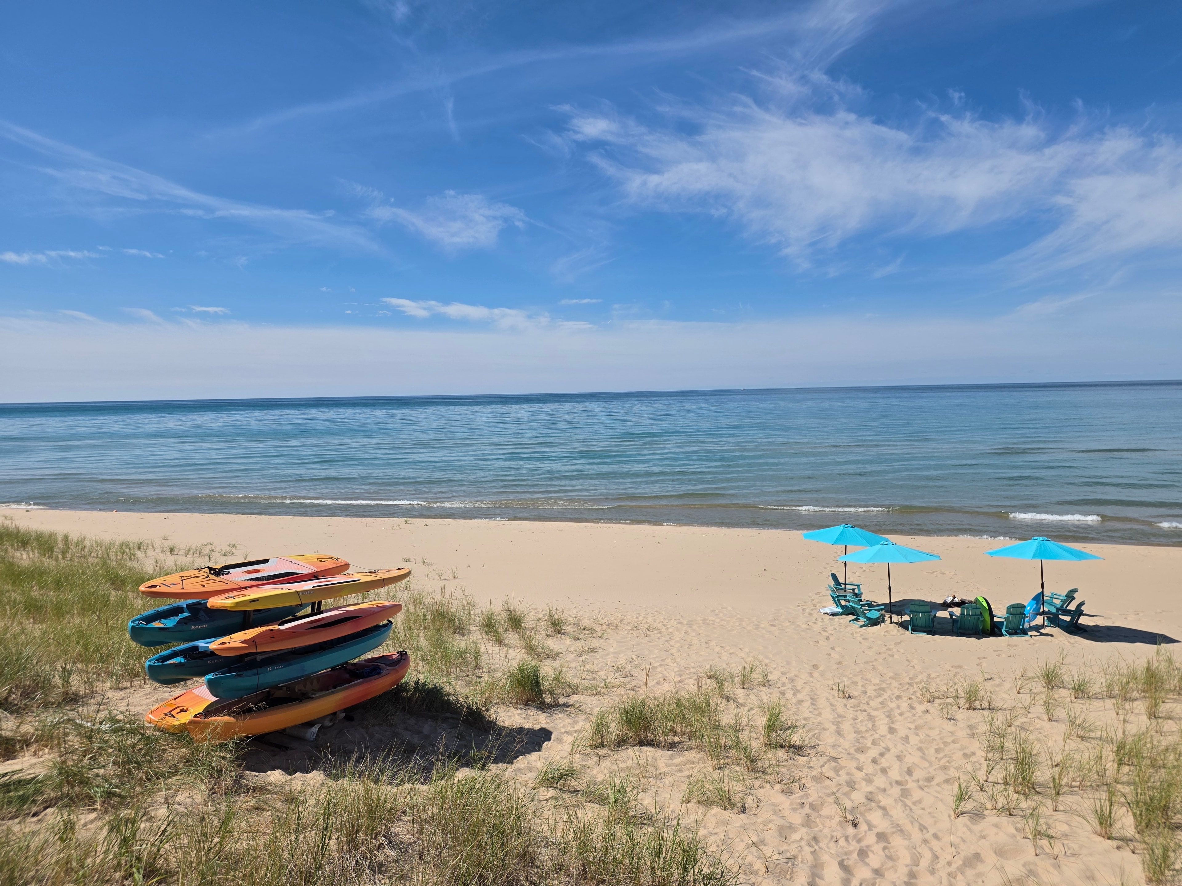 Kayaks and beach umbrellas on the shore