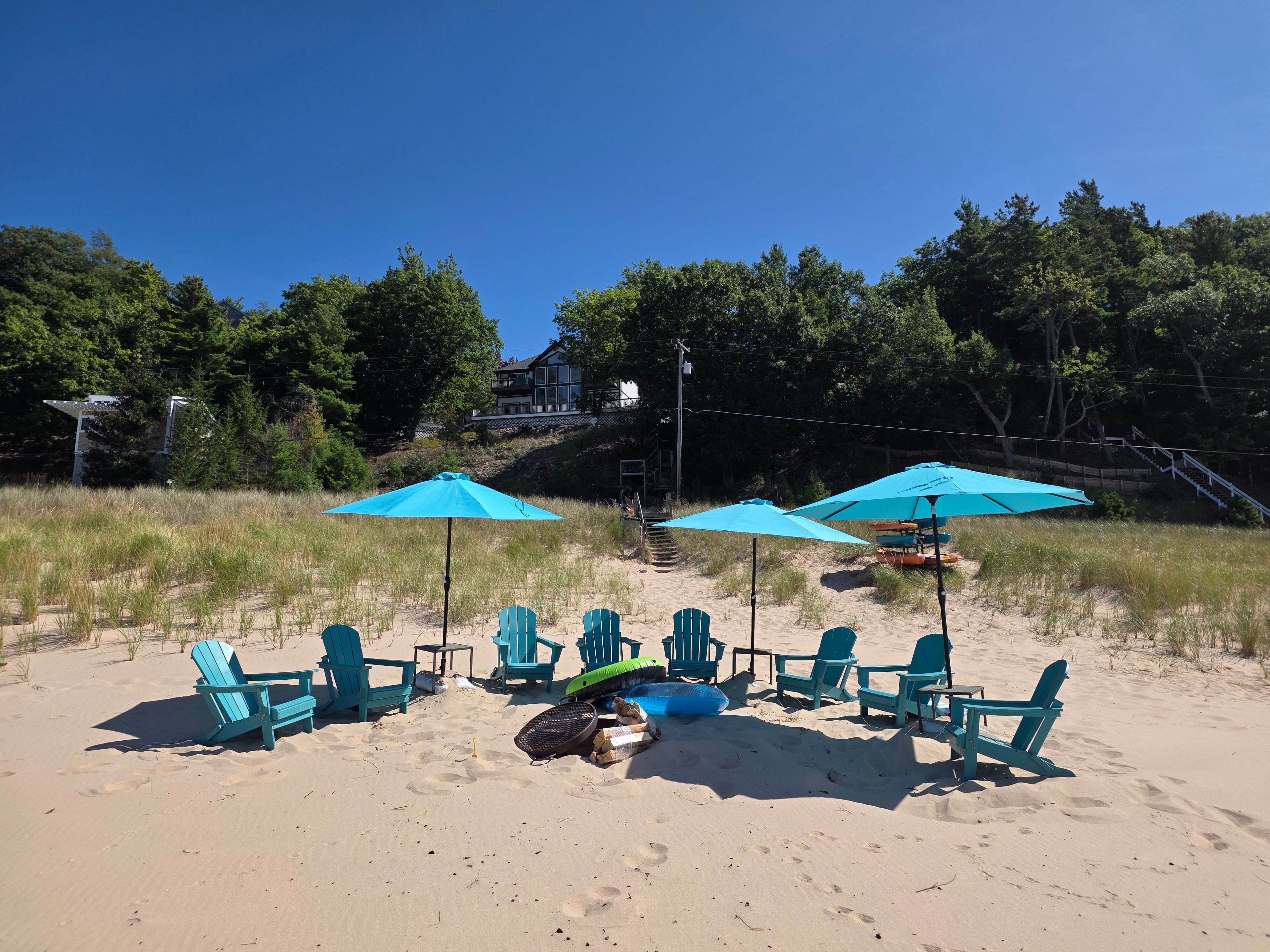 Adirondack chairs and fire pit on the private beach