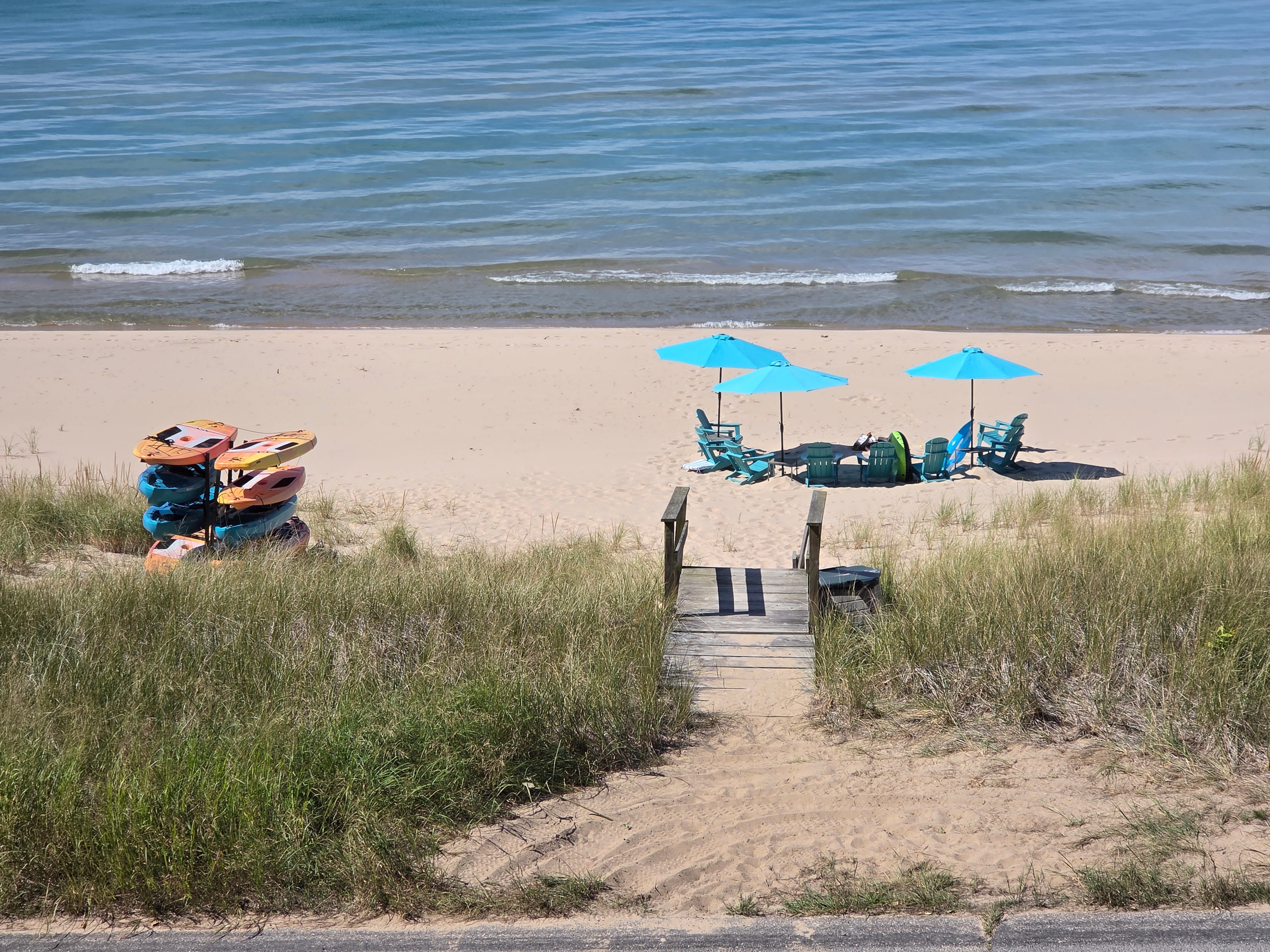 Beach setup with kayaks and umbrellas at Seaglass
